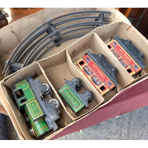 309 - A Brimtoy tin plate boxed train set; an 'O' gauge Lionel Corporation train and another.