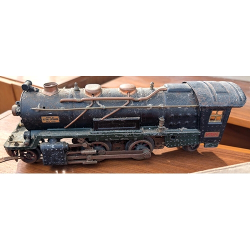 309 - A Brimtoy tin plate boxed train set; an 'O' gauge Lionel Corporation train and another.