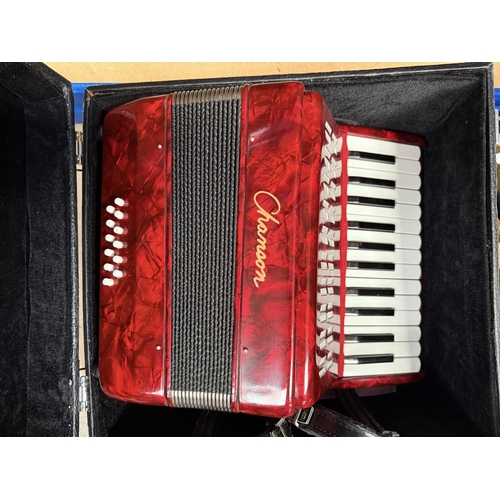 32 - A cased 12 button piano accordion (travel size)