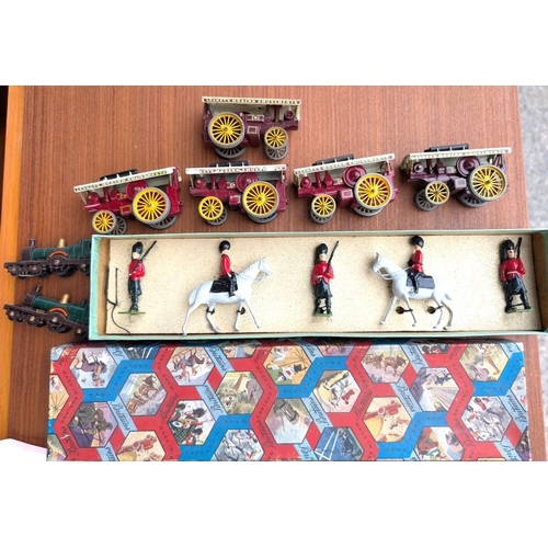 335 - A boxed set of Britain's guards, five Lesney steam traction engines and two trains.