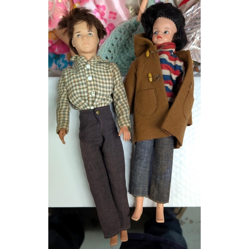 345 - A 1960's first model Sindy and Paul in original outfits and a selection of Barbie dolls, various out... 