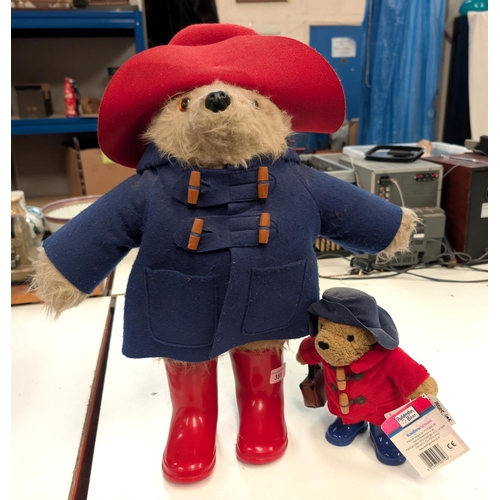 351 - Large Paddington Bear in a blue jacket and red boots, height 53 cm and a smaller one in a red coat a... 