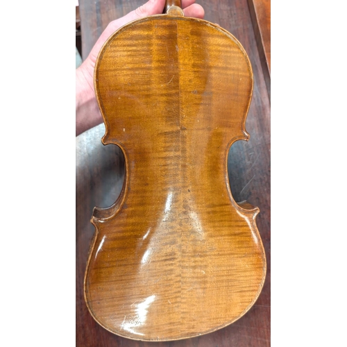 393 - A 19th century violin with spurious label with carved academy detail to back of head, back length 35... 