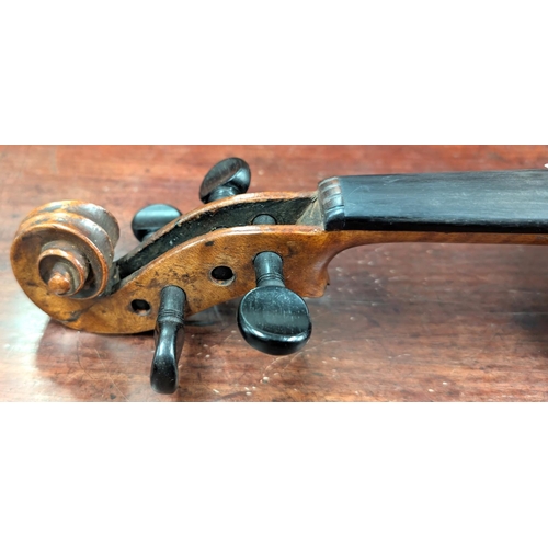 393 - A 19th century violin with spurious label with carved academy detail to back of head, back length 35... 