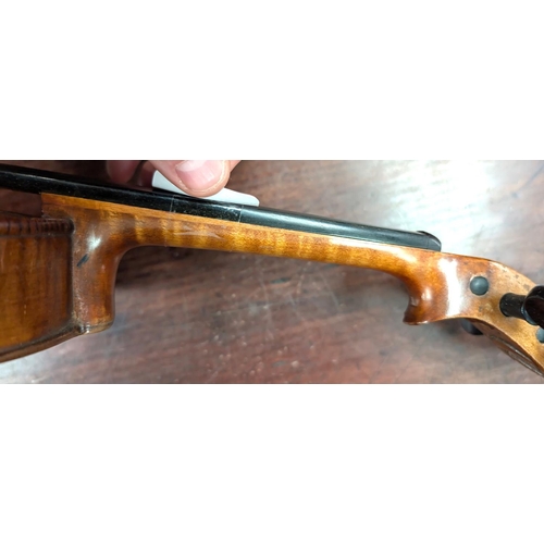 393 - A 19th century violin with spurious label with carved academy detail to back of head, back length 35... 