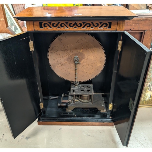 399 - A 'The Britannia' unusual 19th Century upright polyphone disc player in walnut cabinet.