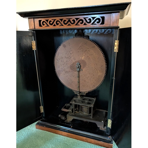 399 - A 'The Britannia' unusual 19th Century upright polyphone disc player in walnut cabinet.