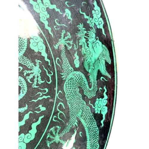 419A - A Chinese black background dish with green dragons to the body, with 6 character mark to the reverse... 