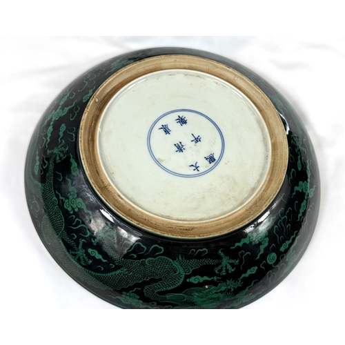 419A - A Chinese black background dish with green dragons to the body, with 6 character mark to the reverse... 