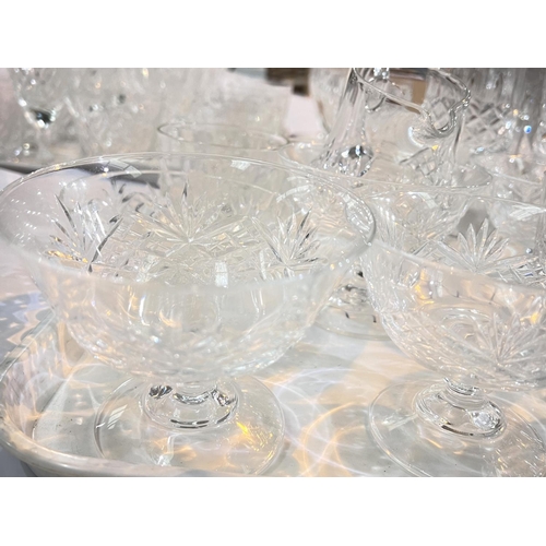 452 - A large selection of cut drinking glasses - tumblers, wines, champagnes etc.