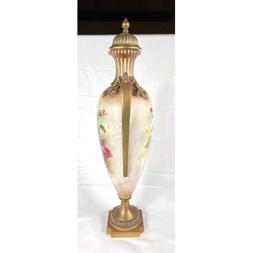 532 - A large Royal Worcester hand-painted lidded urn vase with rose decoration on a gilt and ivory colour... 