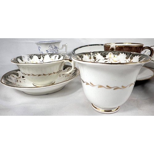 541 - An early Rockingham style trio set in grey and gilt, comprising a tea cup, coffee cup and saucer; a ... 