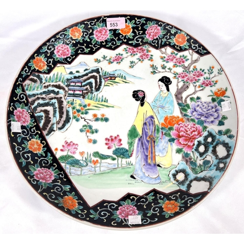 553 - A mid 20th century circular Chinese famille vert style charger, decorated with 2 women in a landscap... 