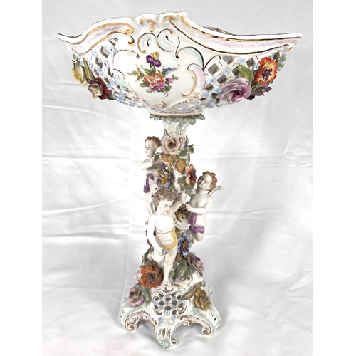 555 - A late 19th century DRESDEN porcelain table centre with naturalistic column with three putti on trif... 