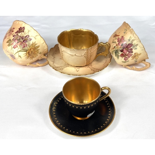 595 - Royal Worcester: a gilded blak cabinet cup and saucer, another with peach ground and a further pair ... 