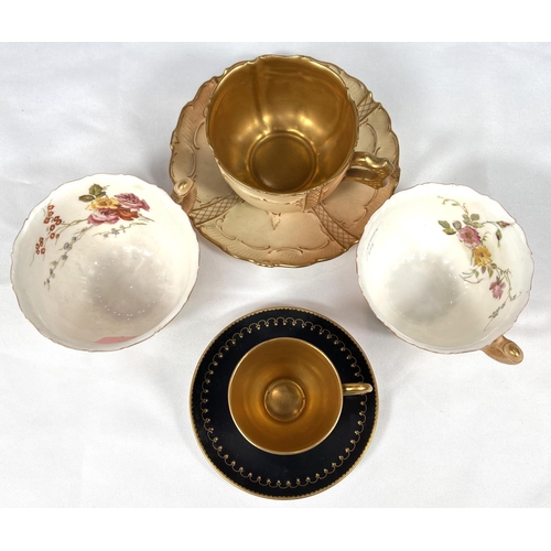 595 - Royal Worcester: a gilded blak cabinet cup and saucer, another with peach ground and a further pair ... 