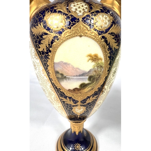 596 - Coalport: a two handled urn wih extensive giltwork and small highland lakescene, 20cm; a Wedgwood lu... 