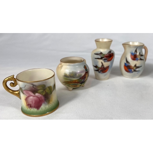 603 - Royal Worcester: A peach ground miniature mug decorated with flowers, 4cm, a similar pair (one a.f.0... 