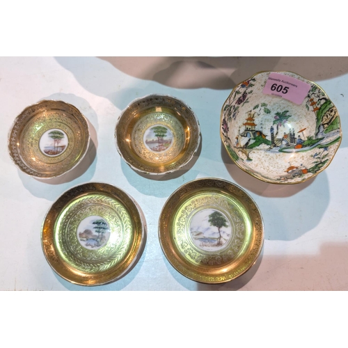 605 - Four continental gilt dishes with central hand painted panel, diameter 9.5cm and a Worcester bowl.