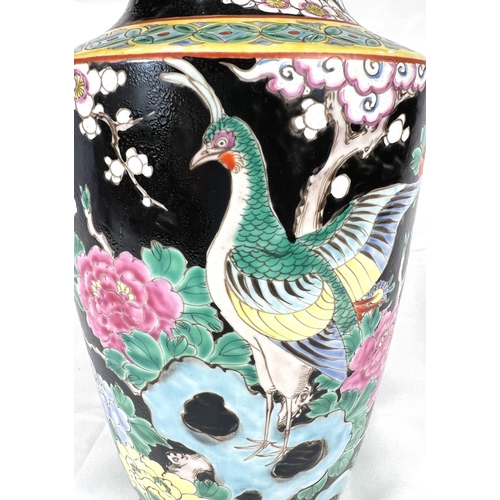 611 - An Eastern porcelain vase circa. 1920 decorated in the famille noir palette, 30cm.