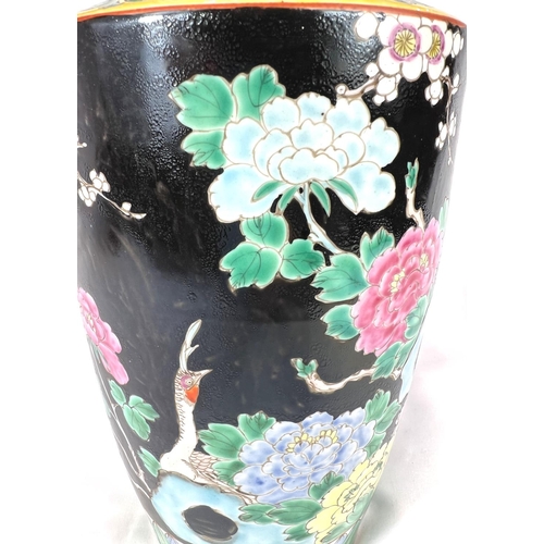 611 - An Eastern porcelain vase circa. 1920 decorated in the famille noir palette, 30cm.