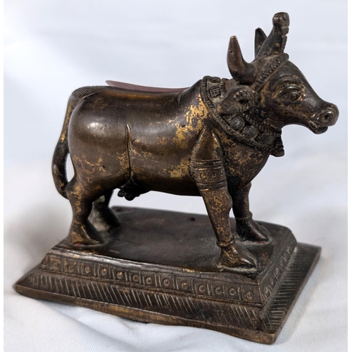 636 - A 19th century Indian gilt bronze Nandi Cow, length ....