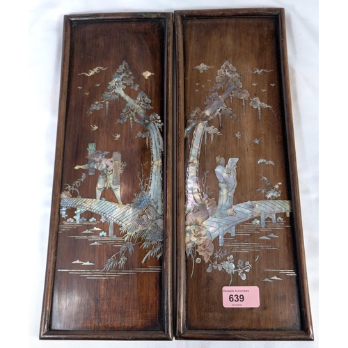 639 - A pair of Chinese mother of pearl inlaid wall plaques with scholars and fishermen.