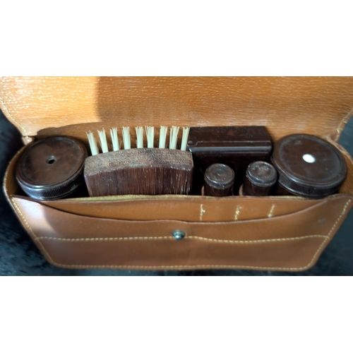 66 - A white metal three piece dressing table set; a gents Bakelite overnight grooming set, binoculars, r... 