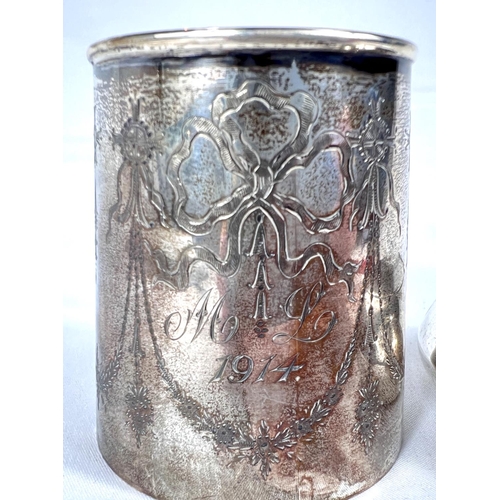 662 - A Christening mug, silver with engraved garlands, Birmingham 1913, 60gm and a cushion shaped silver ... 