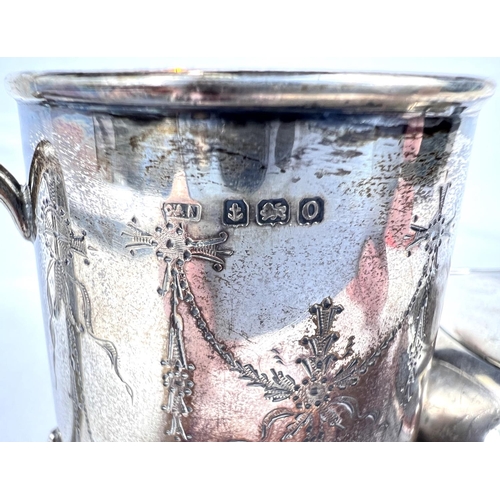 662 - A Christening mug, silver with engraved garlands, Birmingham 1913, 60gm and a cushion shaped silver ... 