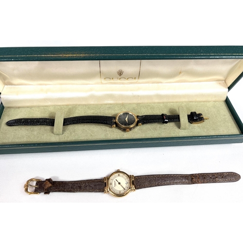 664 - GUCCI - a lady's wristwatch, quartz movement, original box and RAYMOND WEIL - a lady's wristwatch.