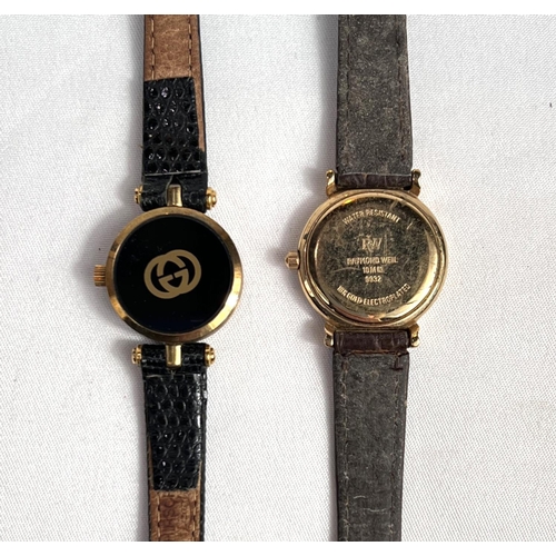 664 - GUCCI - a lady's wristwatch, quartz movement, original box and RAYMOND WEIL - a lady's wristwatch.