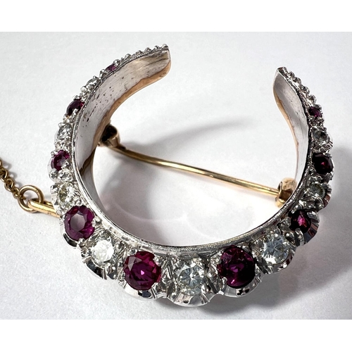 679 - A crescent brooch, white and yellow gold set graduating alternating diamonds and rubies, London 1983... 