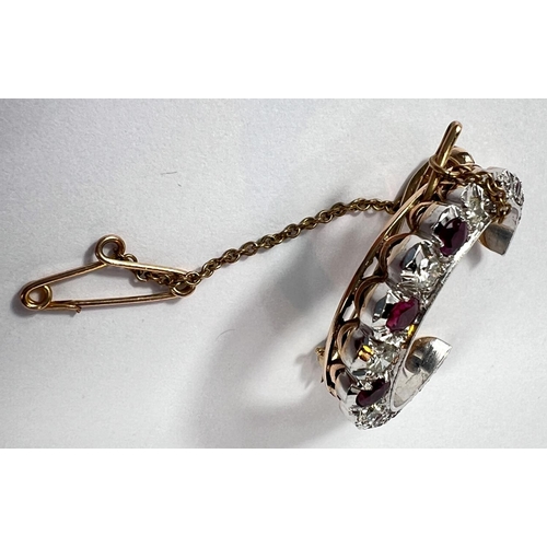 679 - A crescent brooch, white and yellow gold set graduating alternating diamonds and rubies, London 1983... 