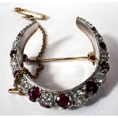 679 - A crescent brooch, white and yellow gold set graduating alternating diamonds and rubies, London 1983... 