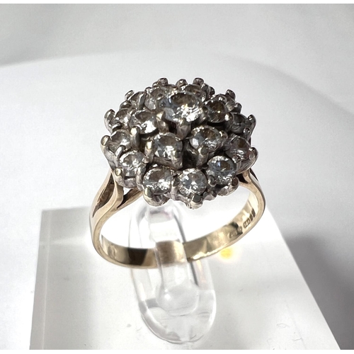 680 - A 9ct yellow gold ring with 19 diamonds in flowerhead setting, 3.8gm gross.