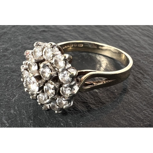 680 - A 9ct yellow gold ring with 19 diamonds in flowerhead setting, 3.8gm gross.