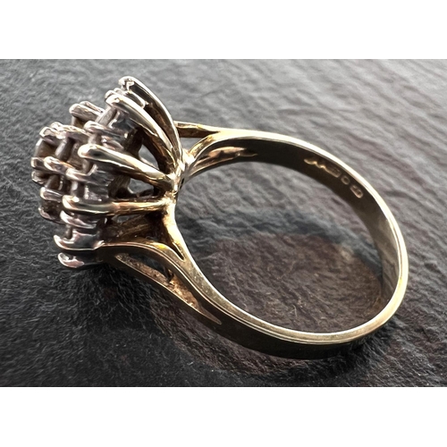 680 - A 9ct yellow gold ring with 19 diamonds in flowerhead setting, 3.8gm gross.