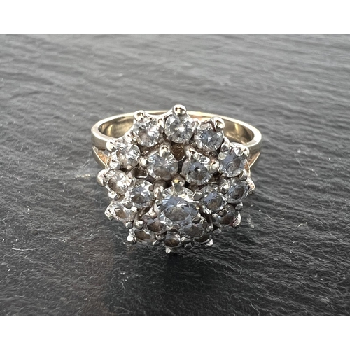 680 - A 9ct yellow gold ring with 19 diamonds in flowerhead setting, 3.8gm gross.