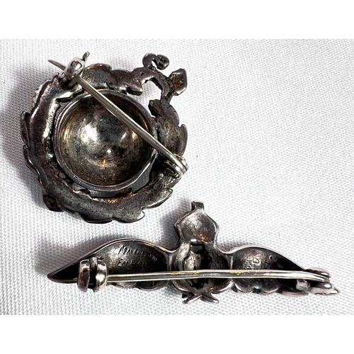 686 - A silver RAF badge with clear stone studded wings and a similar maritime badge with globe and lion.