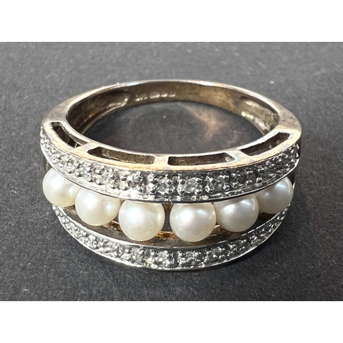 689 - A pearl and diamond ring, 9ct hallmarked yellow gold, central row of 6 pearls with a row of small di... 