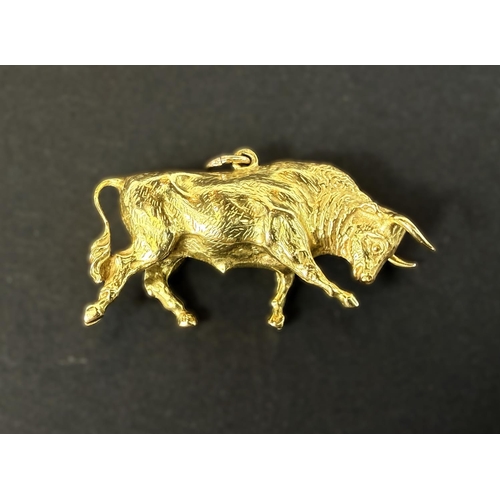 700 - An unmarked yellow metal charm in the form of a bull, 12gms.