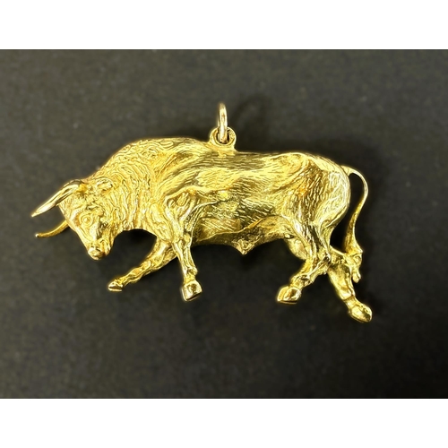 700 - An unmarked yellow metal charm in the form of a bull, 12gms.