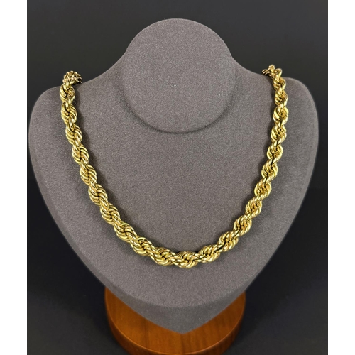 702 - A heavy yellow metal rope twist chain, stamped 14kt, 66.6gms, length 38cm.