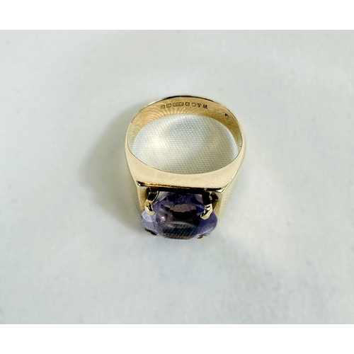 703 - A 9ct hallmarked gold ring set with a large amethyst, 4.3gms, size K