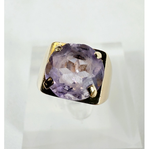 703 - A 9ct hallmarked gold ring set with a large amethyst, 4.3gms, size K