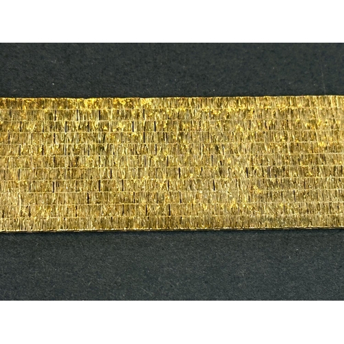 704 - A wide 9ct hallmarked gold bark effect bracelet, 69.5gms, length 18.5cm.