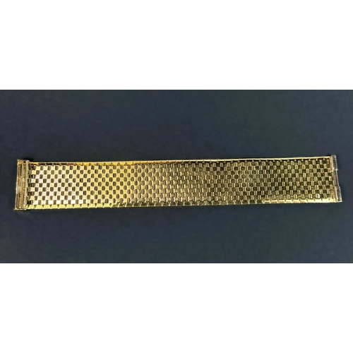 704 - A wide 9ct hallmarked gold bark effect bracelet, 69.5gms, length 18.5cm.