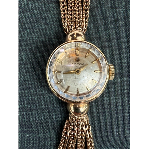 706 - A ladies Omega wristwatch on triple braided strap, stamped 375, gross weight 21gms.