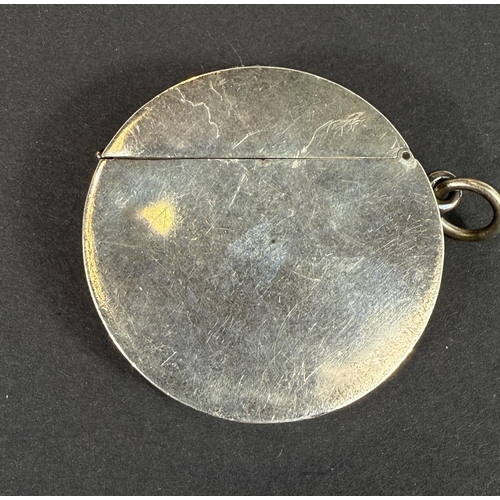 707 - An unusual circular hallmarked silver vesta case depicting a golfer in full swing, Birmingham 1906.